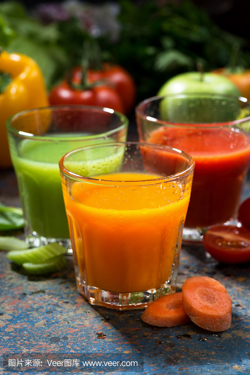 各种蔬菜汁在蓝色背景上垂直