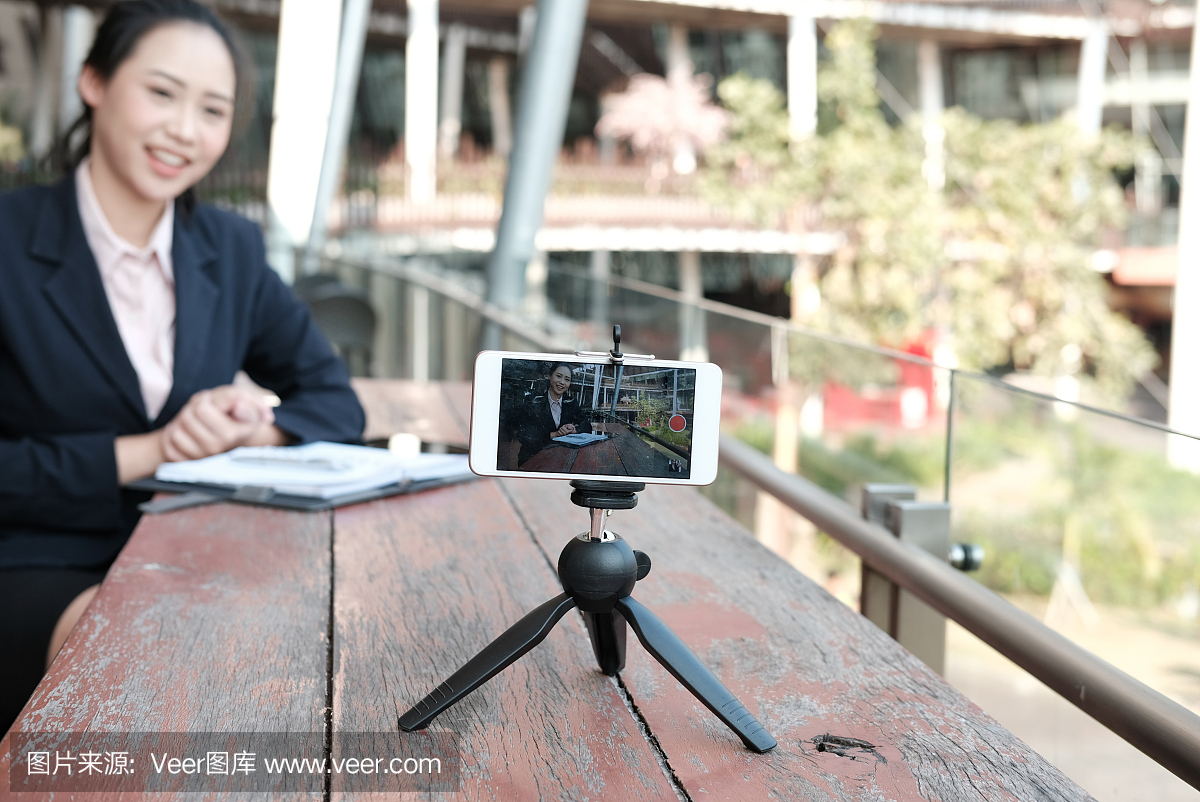 女实业家使用智能手机在线直播。女人录制视频