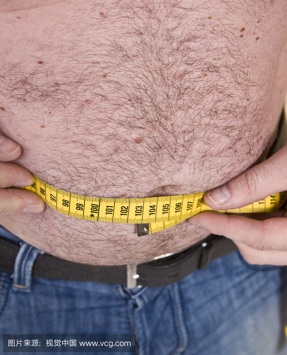 肥胖的男人测量他的长度