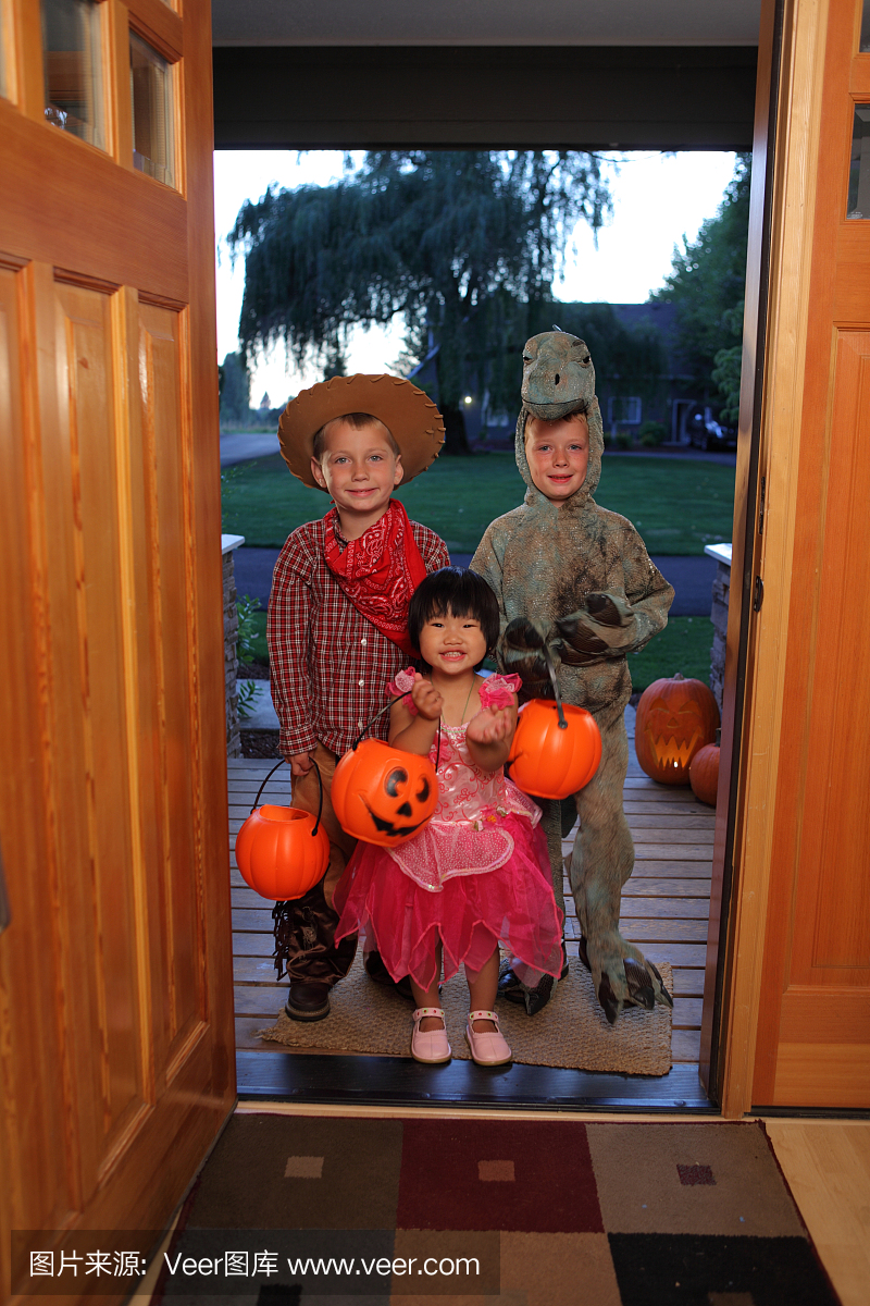 万圣节服饰中的三个孩子玩耍或治疗