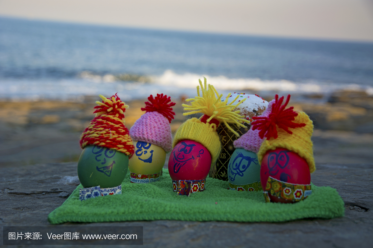 Easter eggs in caps, with funny faces in nature