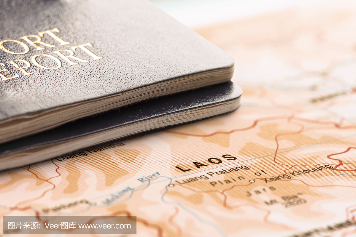 目的地老挝。两张护照在地图上。旅游概念。