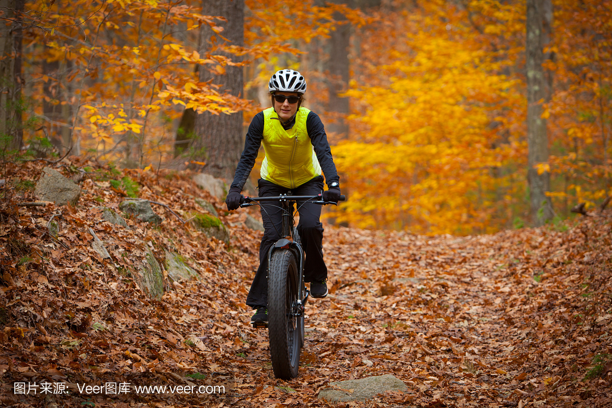 有吸引力的女人在秋天骑摩托车