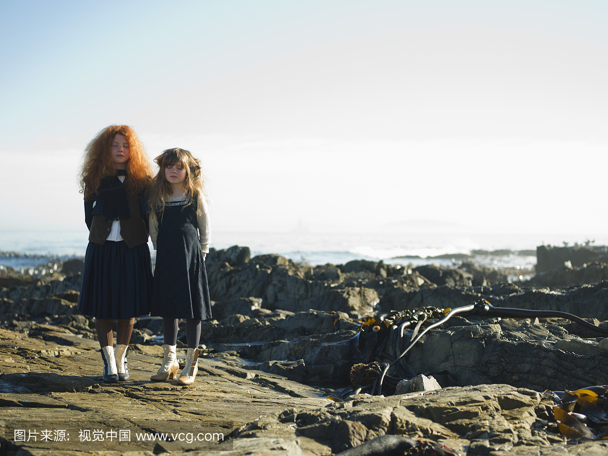 Two sisters ( 7 and 11) outside standing on roc