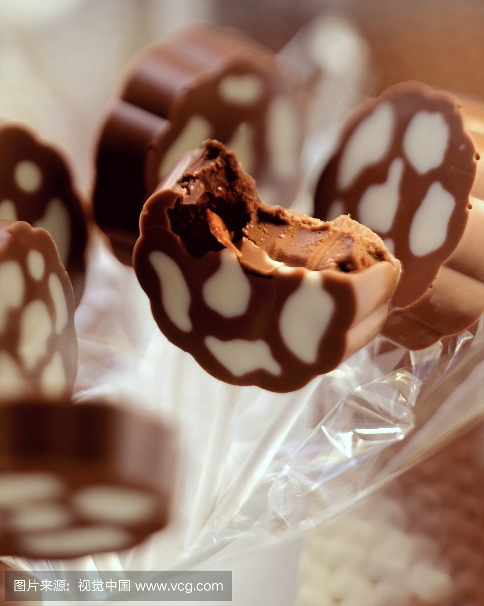 Two-colour (cow markings) chocolates), one bitten