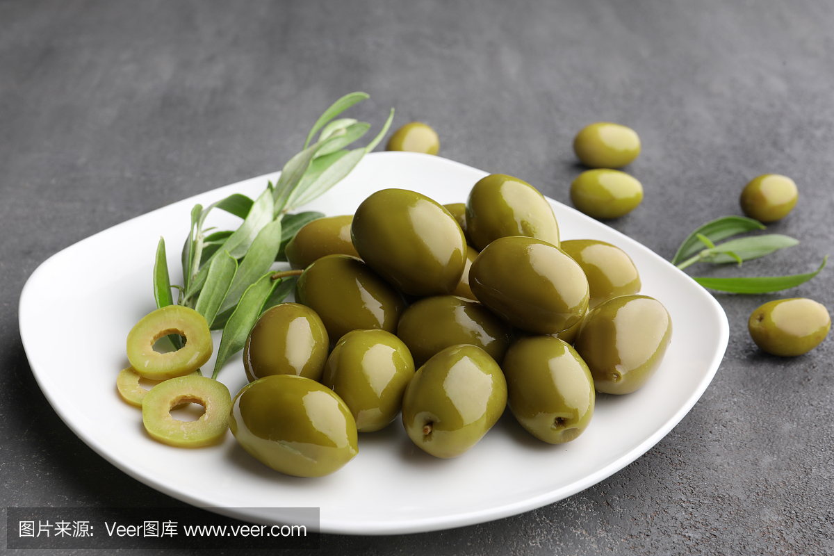 Plate with healthy olives on kitchen table