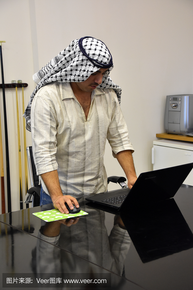 年轻阿拉伯男子在会议室使用笔记本电脑
