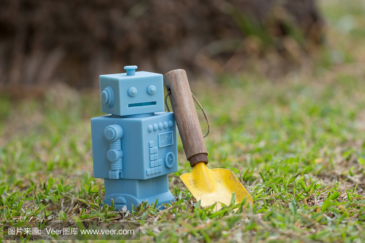蓝色复古机器人玩具与园林工具在天然绿色叶背