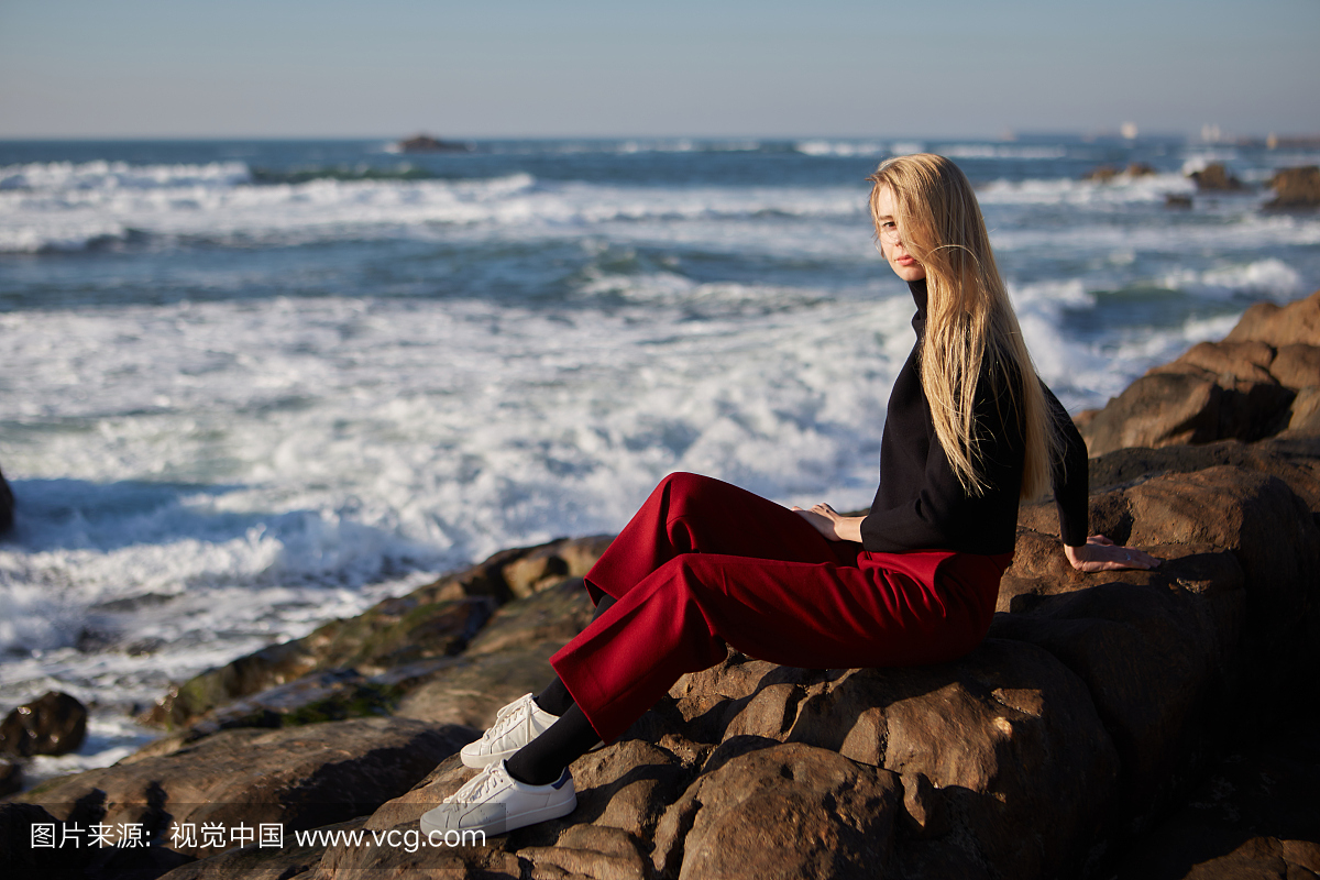 Young woman relaxing near ocean