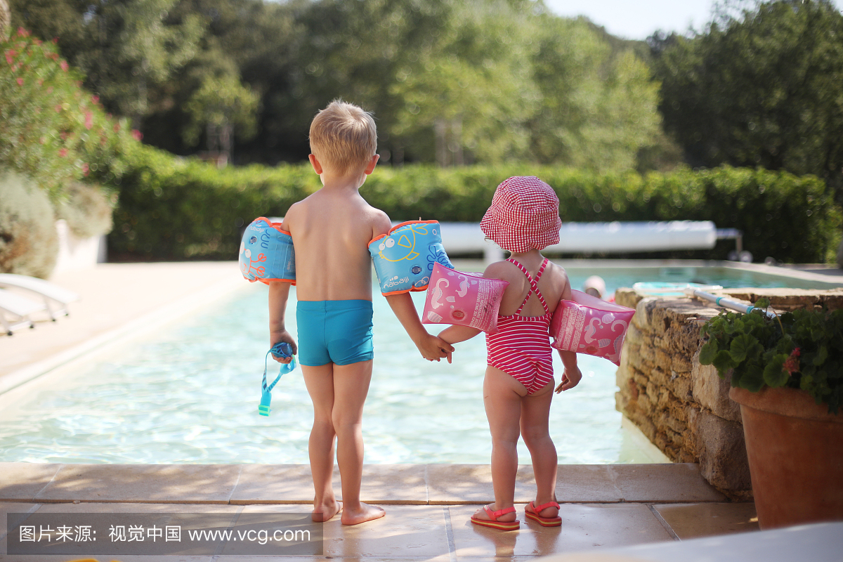 2名儿童在游泳池旁边有水翅膀