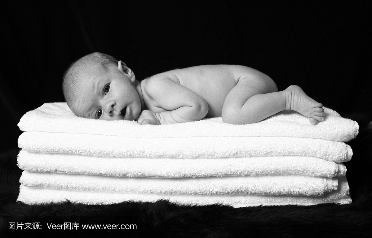 新生婴儿睡在蓬松的毛巾上