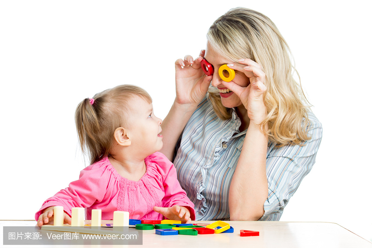 母亲和她的孩子有趣的游戏与彩色玩具